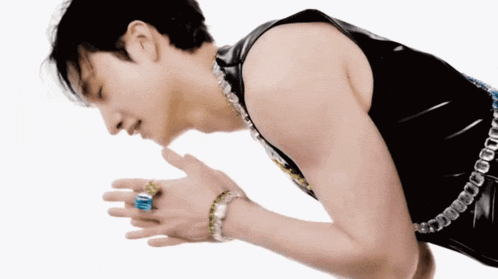 a man wearing a black tank top and a blue ring