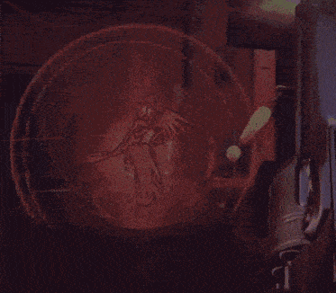 a drawing of a woman with wings and a sword is projected onto a wall