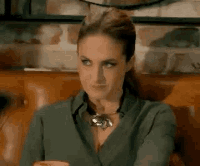 a woman is sitting on a couch with her eyes closed .