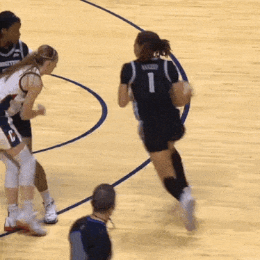 a female basketball player wearing the number 1 jersey