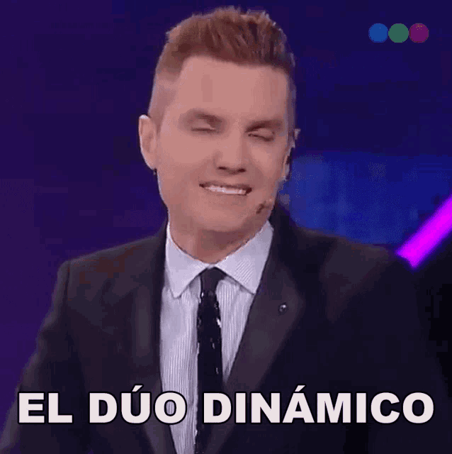 a man in a suit and tie is making a funny face and says el duo dynamico