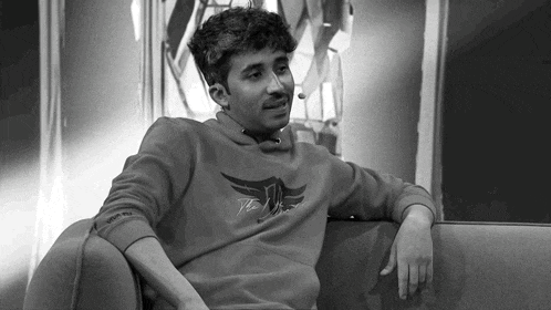a black and white photo of a man wearing a sweatshirt that says " the wings "