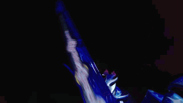 a person is holding a toy sword with a green light coming out of it