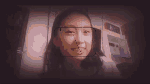 a blurred image of a person 's face with a square in the middle of it