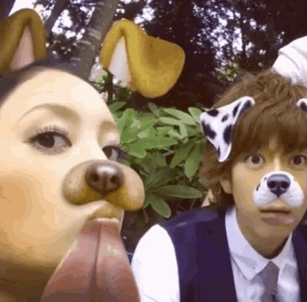 a man and a woman are wearing dog ears on their faces .