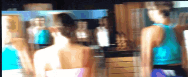 a blurry image of a woman in a blue tank top