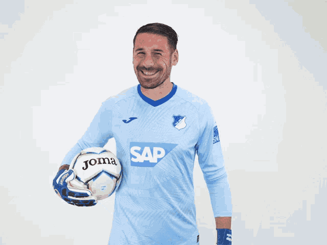 a man wearing a light blue shirt with the word sap on it