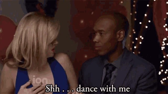 a man and a woman are dancing and the man is saying " shh dance with me "