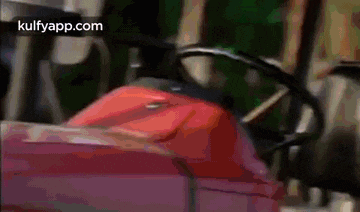 a close up of a red tractor 's steering wheel