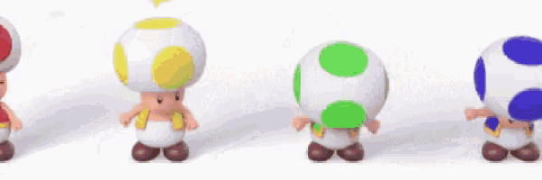 four toads are standing next to each other on a white surface .