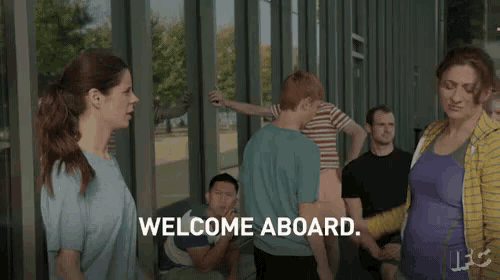 a group of people are standing in front of a building with the words welcome aboard written on the screen