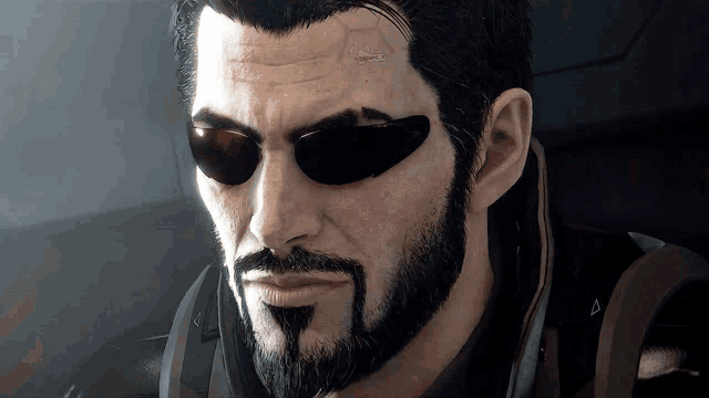 a man with a beard and sunglasses has a sticker on his forehead that says ' a ' on it