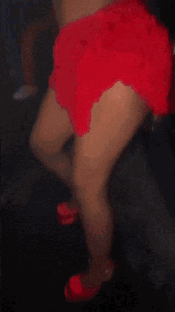 a woman is wearing a red top and pants