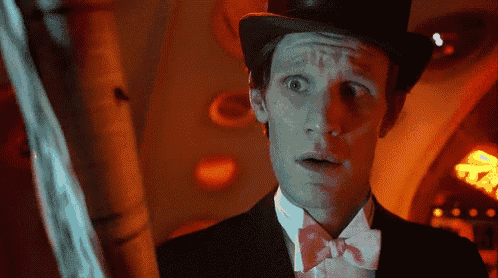 a man wearing a top hat and bow tie is looking surprised