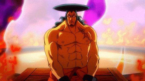 a man with a hat on his head is sitting on a wooden table