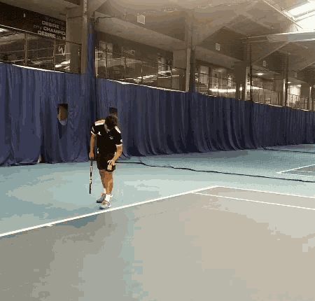 a man holding a tennis racquet on a tennis court with a sign behind him that says " closed "