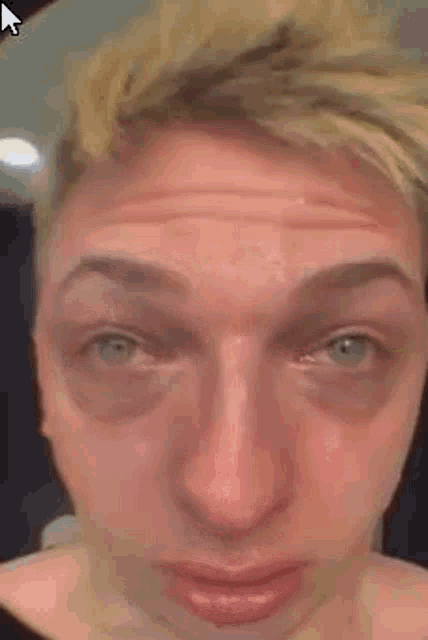 a close up of a man 's face with a funny face .