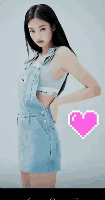 a woman wearing overalls and a bra with calvin klein on it