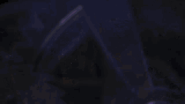 a blurry picture of a person 's face with a purple background .