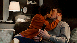 a man and a woman kissing on a couch