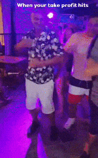 a man in a floral shirt is dancing in a club with purple lights