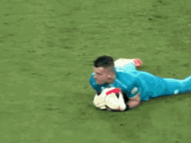 a soccer player with the number 23 on his shirt is laying on the field