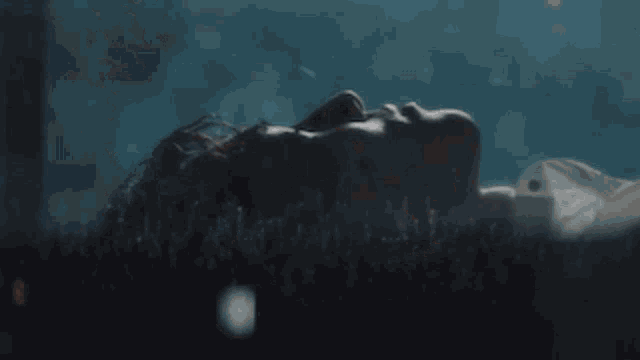 a woman is laying in the water and the words sulto art are visible