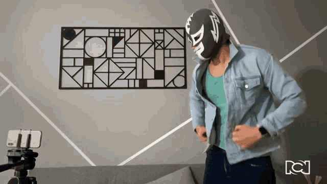 a man wearing a mask with the letter d on it is dancing