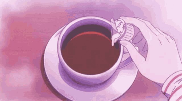 a person is pouring sugar into a cup of coffee with a spoon .