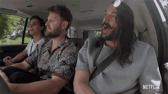 three men are sitting in a car with the word netflix on the bottom