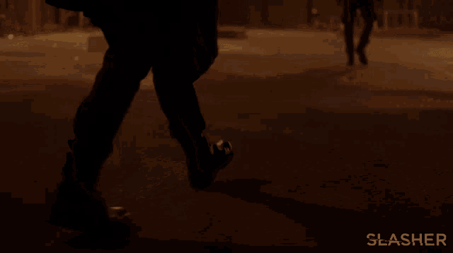 a person walking down a street with the word slasher on the bottom