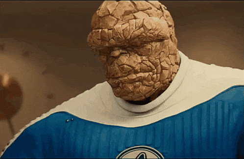 the thing is wearing a blue and white uniform with a fantastic four logo on it