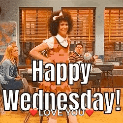 a man in a dress is dancing in a classroom with the words `` happy wednesday ! ``