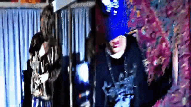 a blurry picture of a person wearing a blue hat and a necklace