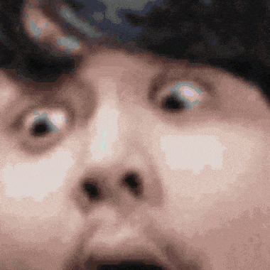 a close up of a person 's face with their eyes wide open