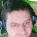 a man wearing headphones is looking at the camera with his eyes closed .