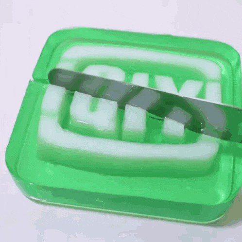 a blender is being used to make a green and white smoothie