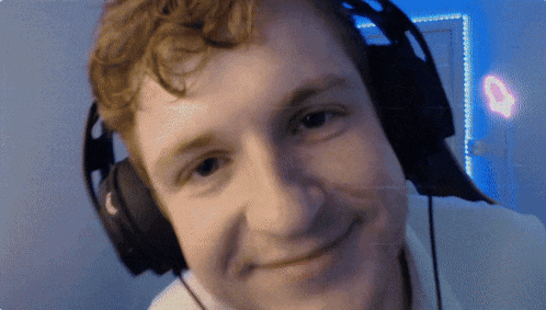 a man wearing headphones looks at the camera