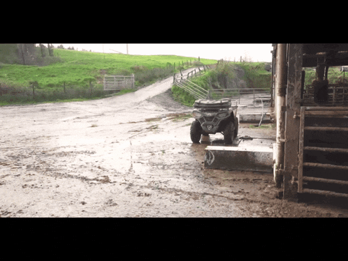 a polaris atv sits in a muddy field