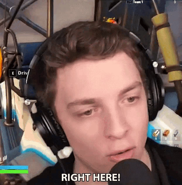 a man wearing headphones is talking into a microphone and says right here