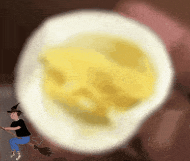 a cartoon of a witch riding a broom in front of a hard boiled egg