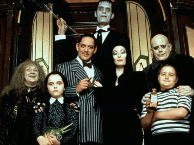 a group of people posing for a picture including addams family