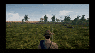 a man in a hat stands in a grassy field