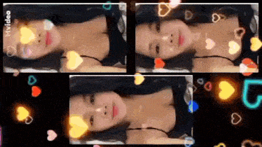 a woman in a black tank top is laying on a bed with hearts surrounding her .