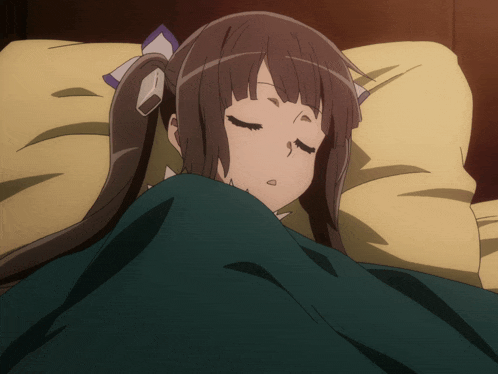 a girl in a bed with her eyes closed and a green blanket