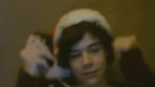 a blurry picture of a person wearing headphones and a hat