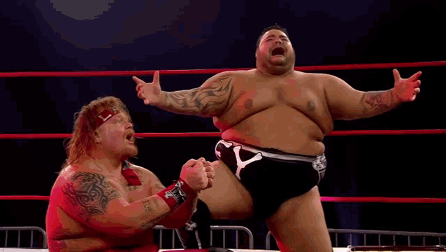 two wrestlers in a ring one of whom is wearing a headband that says ' lss ' on it