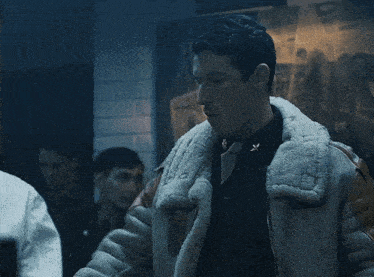 a man wearing a jacket with a fur collar
