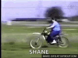 a man is riding a dirt bike and the name shane is on the bottom
