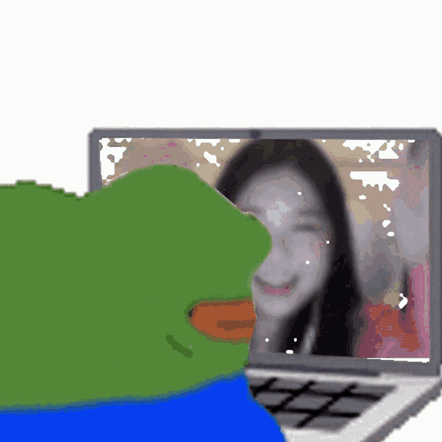 a green frog is looking at a screen with a woman on it